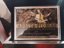 a plaque with a picture of an angel and the words " adeste fideles " on it