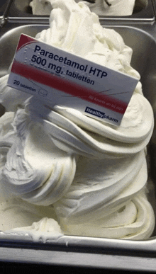 a container of ice cream with a box of paracetamol on top