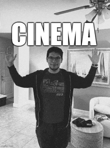 a man standing in a living room with his arms outstretched and the word cinema written above him