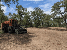 a large orange tractor is parked in a field