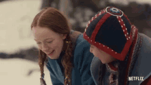 a boy and a girl are standing next to each other in the snow with netflix written on the bottom of the screen