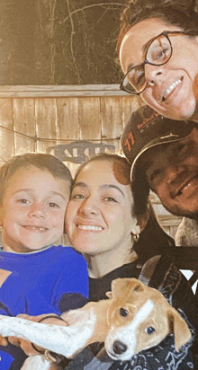 a family posing for a picture with a man wearing a hat that says 71