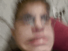 a blurry photo of a person 's face with glasses on .