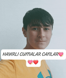 a boy wearing a yellow shirt with the words hayirli cumalar canlar on the bottom