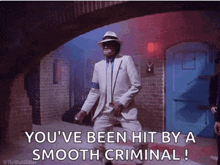 a man in a white suit and hat says " you 've been hit by a smooth criminal ! "