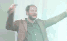 a blurry picture of a man with his arms up