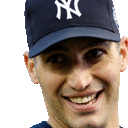 a man wearing a new york yankees hat smiles