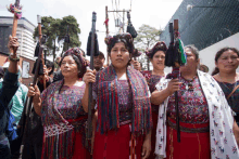 a group of women are holding sticks in their hands and one of them has the letter a on her shirt