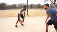 two men are playing basketball on a court and one of them is wearing a shirt that says nike on it