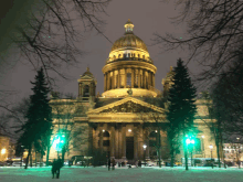 a large building is lit up at night with a dome