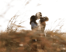 a couple kissing in a field of tall grass