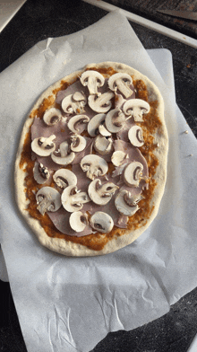 a pizza with mushrooms and ham on it