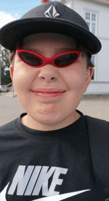 a person wearing sunglasses and a nike shirt