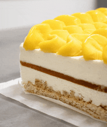 a slice of cake with yellow frosting on top