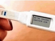 a pregnancy test with the words `` we 're having another gun '' written on it .