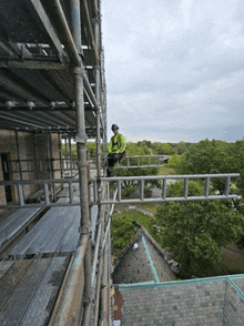 a man sitting on top of a scaffolding structure