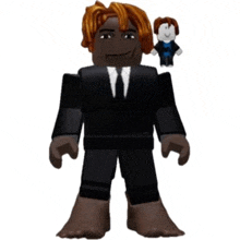 a toy figure of a man in a suit and tie is standing next to another toy figure .