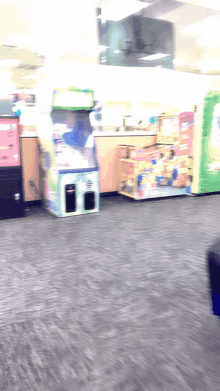 a blurred image of a room with a few arcade games and a vending machine that says coca cola