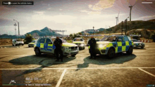 a group of police cars are parked next to each other in a parking lot .