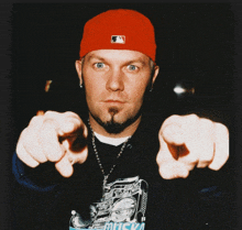 a man wearing a red hat and a black shirt that says music