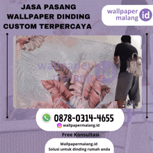 a man is painting a wall with a phone number for wallpaper malang id