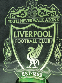 a liverpool football club logo that says " you 'll never walk alone " on it