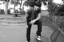 a man sitting on a bench in a park