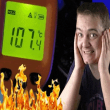 a man is covering his ears in front of a thermometer that reads 107.4