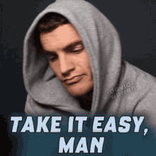 a man wearing a hooded sweatshirt with the words take it easy man below him