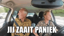 a man and a woman are sitting in a car with the words jij zaait paniek written above them