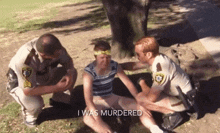 a police officer kneeling down next to a woman with the words " i was murdered " written on the bottom