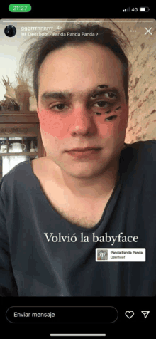 a man with a baby face on his face is on a cell phone