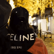 the back of a person wearing a celine sweatshirt