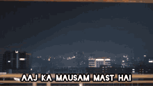 a picture of a city at night with the words aaj ka mausam mast hai below it