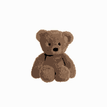 a brown teddy bear is sitting on a white surface