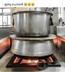 a large pot is sitting on top of a smaller pot on a stove .