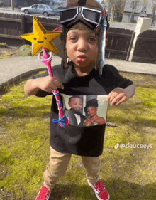 a young boy wearing a helmet and goggles is holding a toy wand