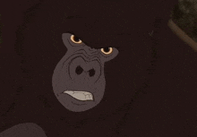 a close up of a gorilla 's face with an angry look on its face .