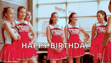 a group of cheerleaders are standing in a classroom with the words `` happy birthday '' written on the screen .