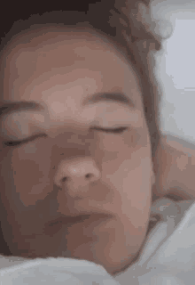 a close up of a person sleeping with their eyes closed