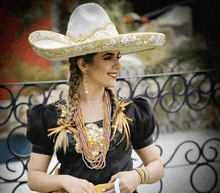 a woman wearing a sombrero and a black dress