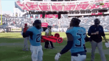 a group of football players are standing on a field . one of the players is wearing a number 31 jersey .