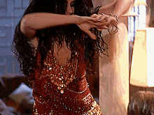 a woman in a red dress is dancing in a room .