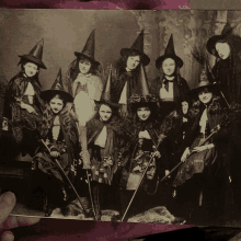 a group of witches are posing for a picture