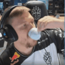 a man wearing headphones and a shirt that says red bull