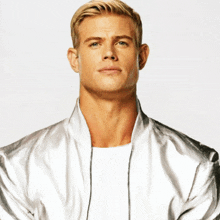 a man wearing a silver jacket and a white shirt