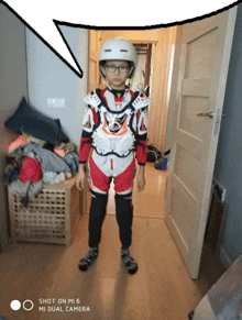 a boy wearing a helmet is standing in front of a door with a speech bubble above him that says shot on mi 6