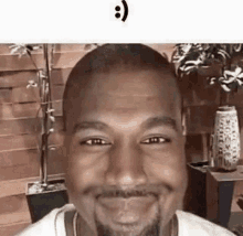 a close up of a man 's face with a beard smiling .