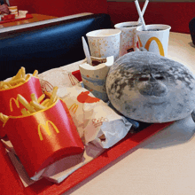 a tray of mcdonald 's french fries and a stuffed seal