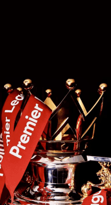 a silver trophy with red ribbons that say premier